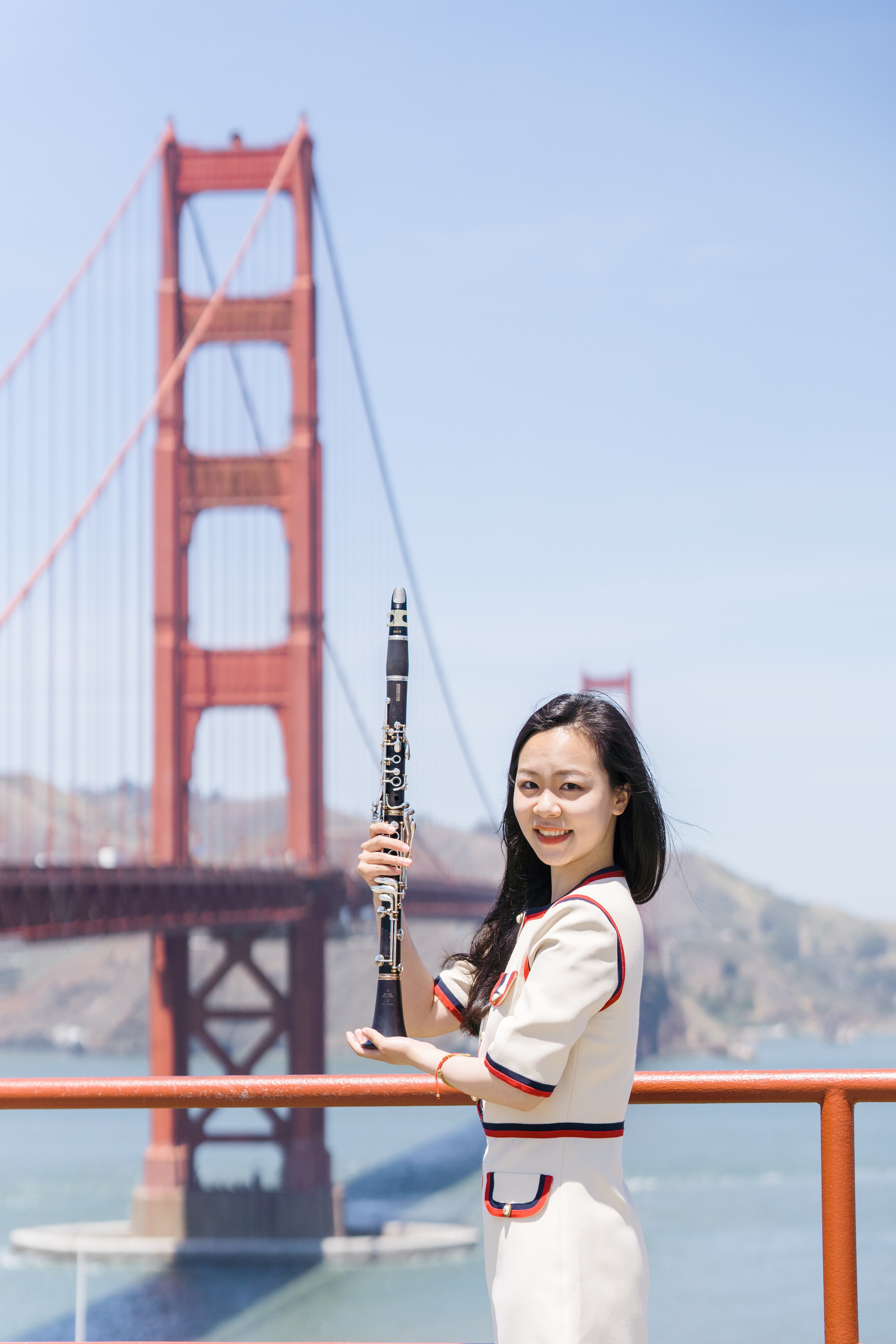 Yijin Wang with her clarinet at the Golden Gate Bridge